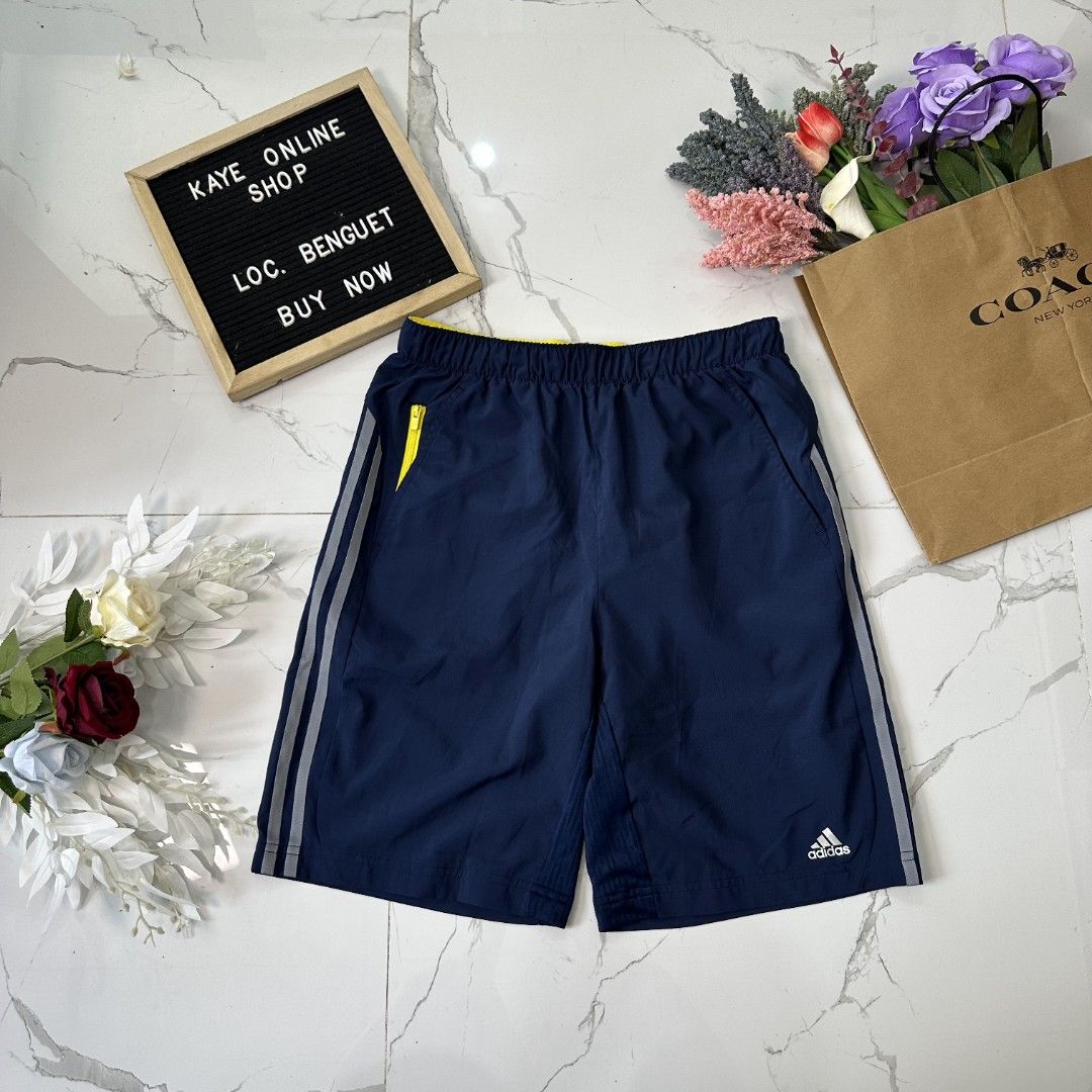 Climacool Adidas Shorts (Category: Shorts) located in Baguio. Submitted by kayeonlineshop (Listing ID 1461020332, Image 2). Description: navy blue Adidas athletic shorts featuring white side stripes and a small yellow accent near the waistband l20 w28-38 h22.