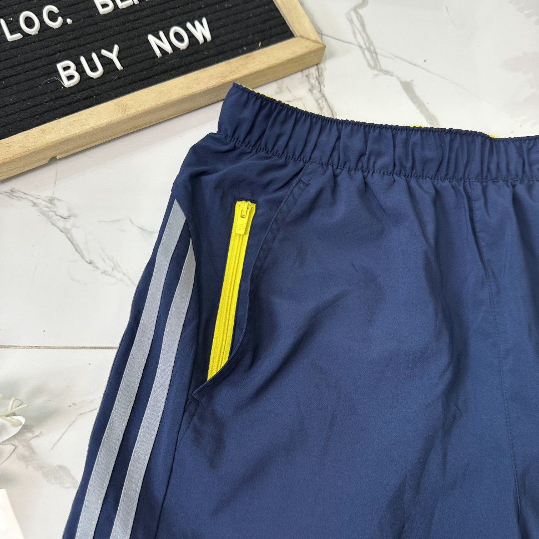 Climacool Adidas Shorts (Category: Shorts) located in Baguio. Submitted by kayeonlineshop (Listing ID 1461020332, Image 3). Description: navy blue Adidas athletic shorts featuring white side stripes and a small yellow accent near the waistband l20 w28-38 h22.