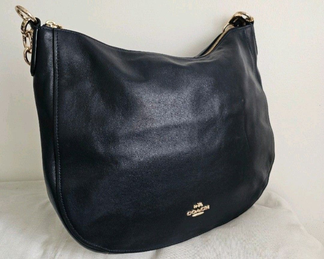 Coach Leather Hobo Shoulder Bag (Category: Luxury Bags & Wallets) located in Manila. Submitted by selah_ (Listing ID 1460964025, Image 1). Description: - Classic Coach hobo bag - Made from soft leather - Features gold hardware details - Secure top zipper closure - Spacious interior for essentials - Ideal for everyday use - clean interior - straps srill wrapped.
