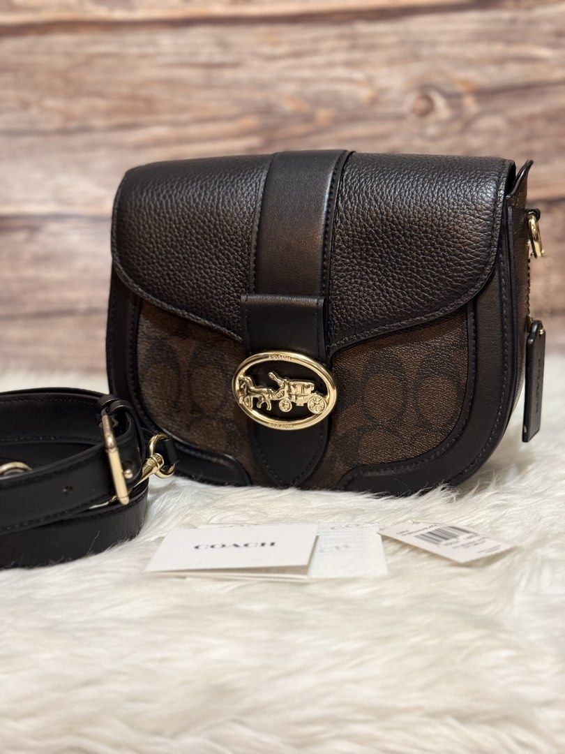 Coach Georgie Saddle Mahogany/black (Category: Cross-body Bags) located in Pasig City. Submitted by akmonlineboutique (Listing ID 1460945030, Image 1). Description: Preloved in good condition 💯Original with tag slightly used but expect minimal sign of use with super liit na crease mark on top Pasig loc first to pay. no reservation.