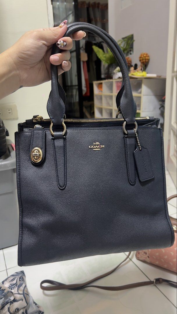 Coach Pebbled Leather Satchel Handbag (Category: Luxury Bags & Wallets) located in Bulacan. Submitted by heyitsmarf (Listing ID 1460921818, Image 1). Description: - Dark navy blue pebbled leather Coach satchel - Elegant gold hardware details - Secure turn-lock closure on front pocket - Zip-top closure for main compartment - Includes a detachable crossbody strap for versatile carrying - Very spacious interior, ideal for daily essentials - A stylis