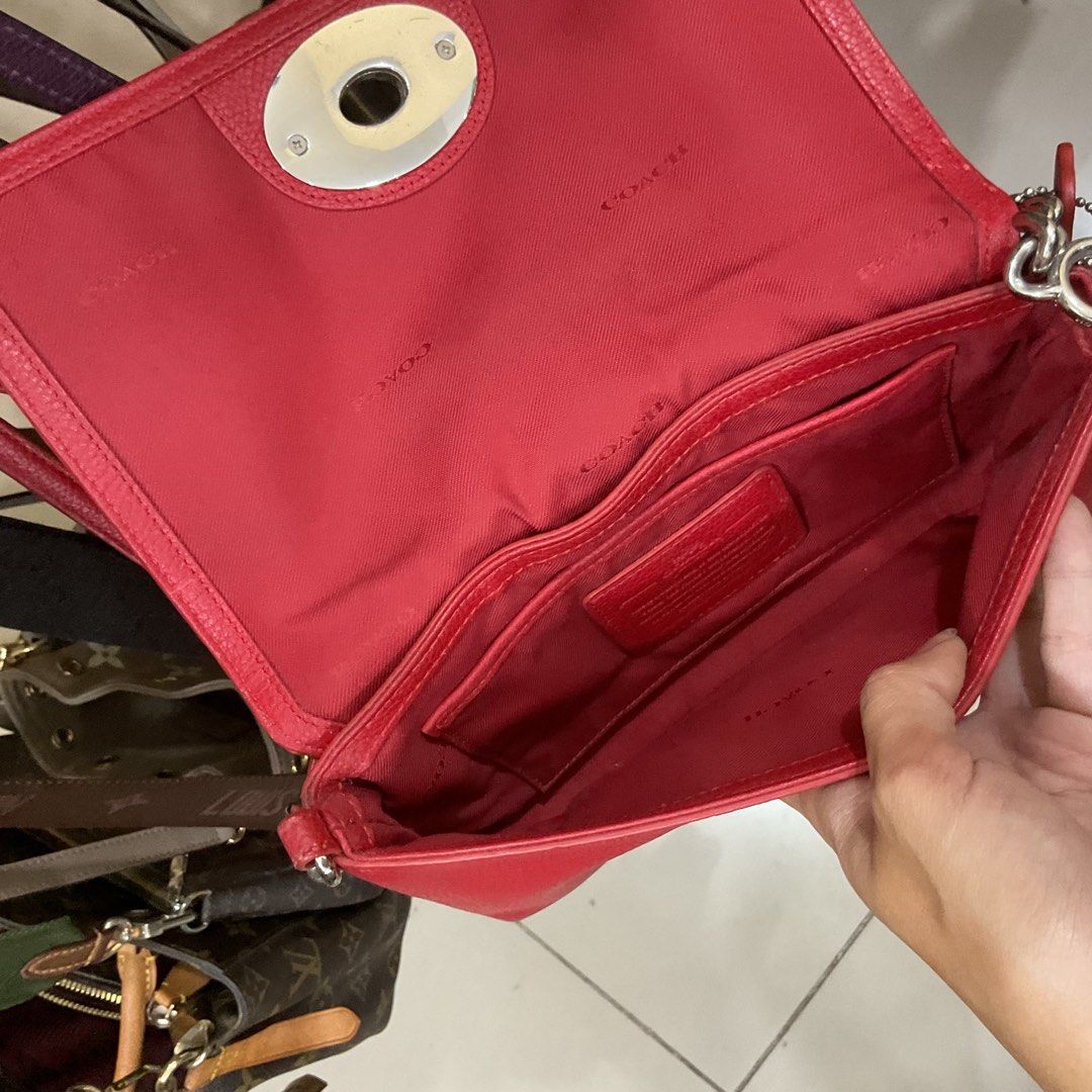 Coach Red Leather Turnlock Crossbody Bag (Category: Luxury Bags & Wallets) located in Manila. Submitted by asianbellahadidd (Listing ID 1461033591, Image 3). Description: - Authentic Coach red leather crossbody bag - Secure turnlock closure on the front - Interior features multiple slip pockets - Signature Coach logo pattern lining - Sleek silver hardware - Ideal for everyday wear and errands.