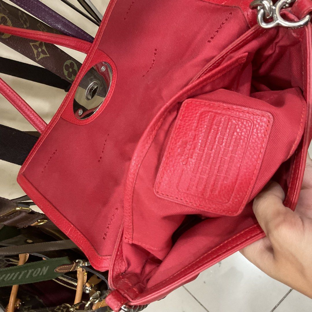 Coach Red Leather Turnlock Crossbody Bag (Category: Luxury Bags & Wallets) located in Manila. Submitted by asianbellahadidd (Listing ID 1461033591, Image 2). Description: - Authentic Coach red leather crossbody bag - Secure turnlock closure on the front - Interior features multiple slip pockets - Signature Coach logo pattern lining - Sleek silver hardware - Ideal for everyday wear and errands.