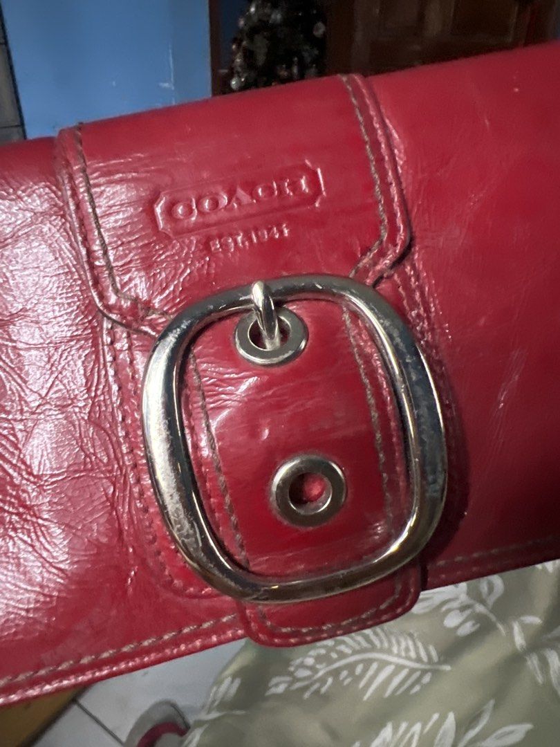 Coach Red Leather Wallet with Buckle (Category: Luxury Bags & Wallets) located in Lipa City. Submitted by wen_68 (Listing ID 1460993777, Image 2). Description: - Genuine red leather Coach wallet - Secure silver buckle closure on front flap - Multiple interior compartments for organization - Zippered pocket for added security - Minor cosmetic marks inside, does not affect functionality - Plenty of life left, great value!.