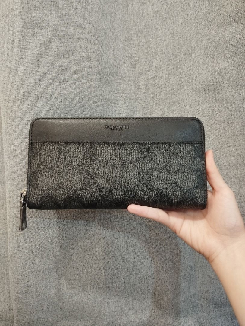 Coach Signature Zip Around Wallet (Category: Wallets & Card holders) located in Caloocan City. Submitted by mkaelav (Listing ID 1461086513, Image 1). Description: - Coach signature print wallet - Black and grey colorway - Secure zip-around closure - Ample space for cards and cash - Timeless Coach design.