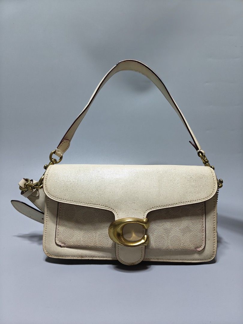 Coach Tabby Shoulder Bag 26 Cream (Category: Luxury Bags & Wallets) located in Manila. Submitted by baguiogirlyy (Listing ID 1460921459, Image 1). Description: - Cream colored Coach bag - Signature gold 'C' hardware - Adjustable strap for versatile wear - Minor signs of wear on edges and hardware - Ideal for everyday use.