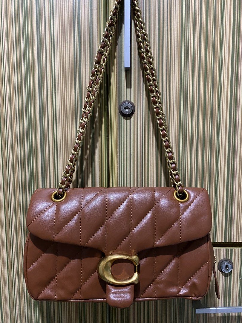 Coach Tabby Shoulder Bag 26 in Brown (Category: Luxury Bags & Wallets) located in Taguig. Submitted by sandzclick (Listing ID 1461015239, Image 1). Description: - Brown quilted leather shoulder bag - Gold chain strap - Iconic Coach C hardware - Spacious interior for essentials - Perfect for day or night use - Matches most outfits - A classic addition to your collection.