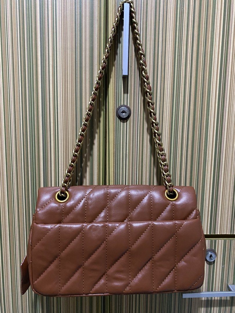 Coach Tabby Shoulder Bag 26 in Brown (Category: Luxury Bags & Wallets) located in Taguig. Submitted by sandzclick (Listing ID 1461015239, Image 2). Description: - Brown quilted leather shoulder bag - Gold chain strap - Iconic Coach C hardware - Spacious interior for essentials - Perfect for day or night use - Matches most outfits - A classic addition to your collection.