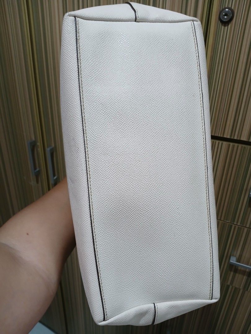 Coach White Leather Tote Bag (Category: Luxury Bags & Wallets) located in Taguig. Submitted by demsclosetph (Listing ID 1461005240, Image 3). Description: - Coach white leather tote bag - Elegant gold hardware details - Secure top zip closure - Roomy interior for all your essentials - Comfortable shoulder straps for easy carrying - Versatile for everyday use or travel - Timeless and classic design.