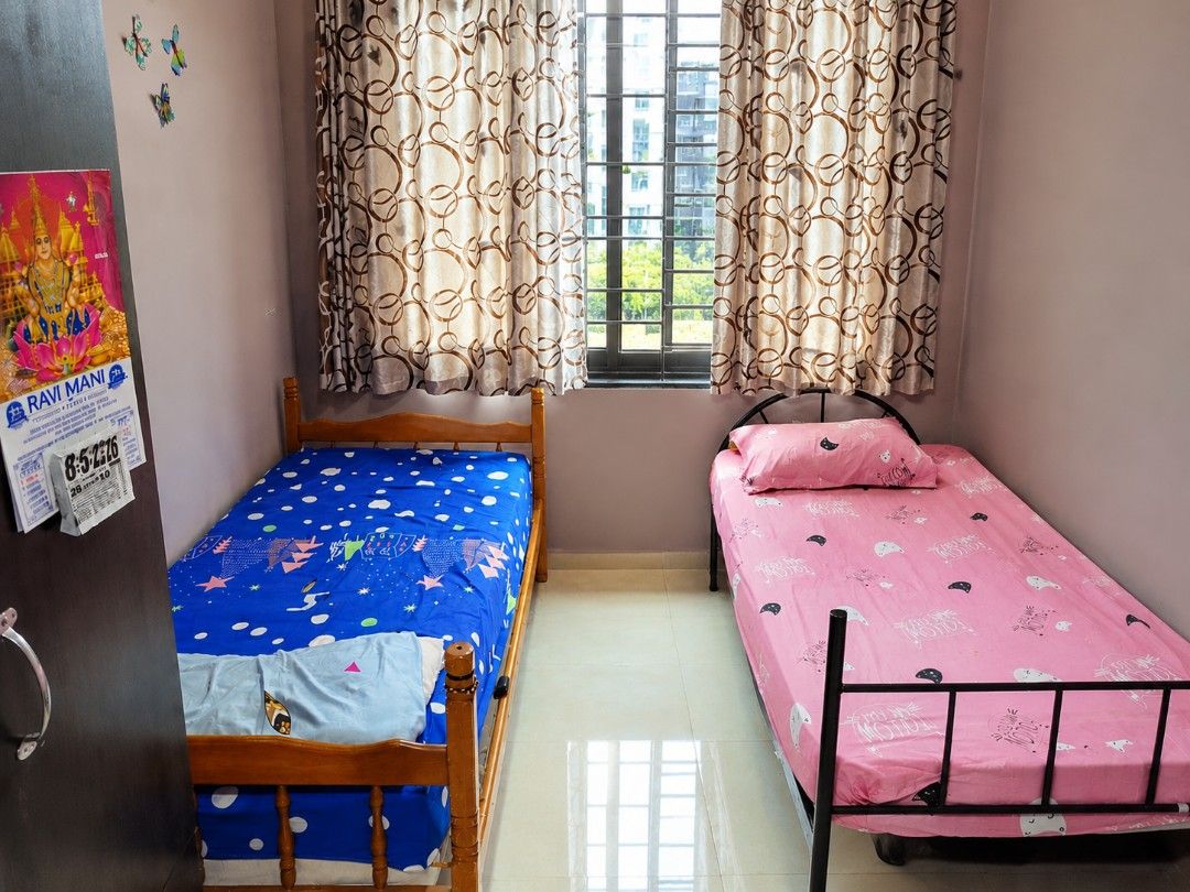 Common room (Category: Bed Frames & Mattresses) located in Singapore. Submitted by vj_kishore (Listing ID 1461010721, Image 1). Description: - Two single beds with blue and pink bedding - Separate bathroom with sink and toilet - Kitchenette area with stove and refrigerator - Hallway with multiple doors - Ready for viewing.