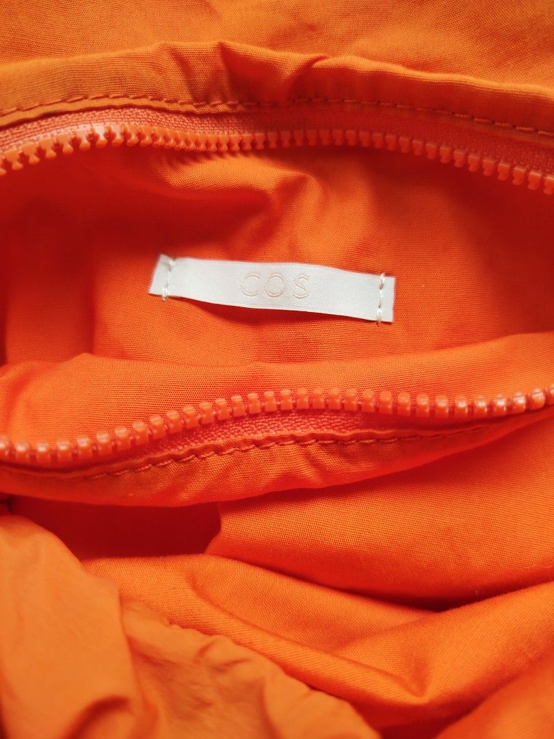 COS Orange Puffy Bag (Category: Shoulder Bags) located in Calamba. Submitted by merrymerida (Listing ID 1460957782, Image 2). Description: - Brand: COS - Color: Orange - Closure: Zip main compartment - Interior: Small zip pocket - Features: Unique shape, bright color - Ideal for: Everyday use, travel.