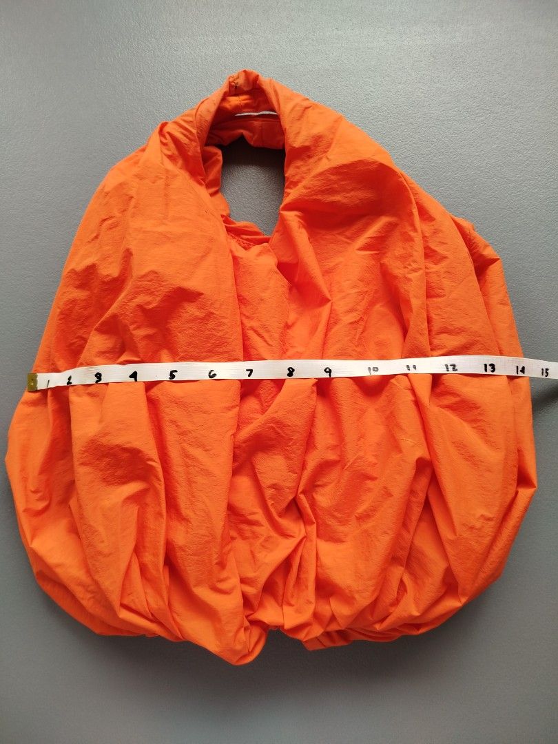 COS Orange Puffy Bag (Category: Shoulder Bags) located in Calamba. Submitted by merrymerida (Listing ID 1460957782, Image 3). Description: - Brand: COS - Color: Orange - Closure: Zip main compartment - Interior: Small zip pocket - Features: Unique shape, bright color - Ideal for: Everyday use, travel.
