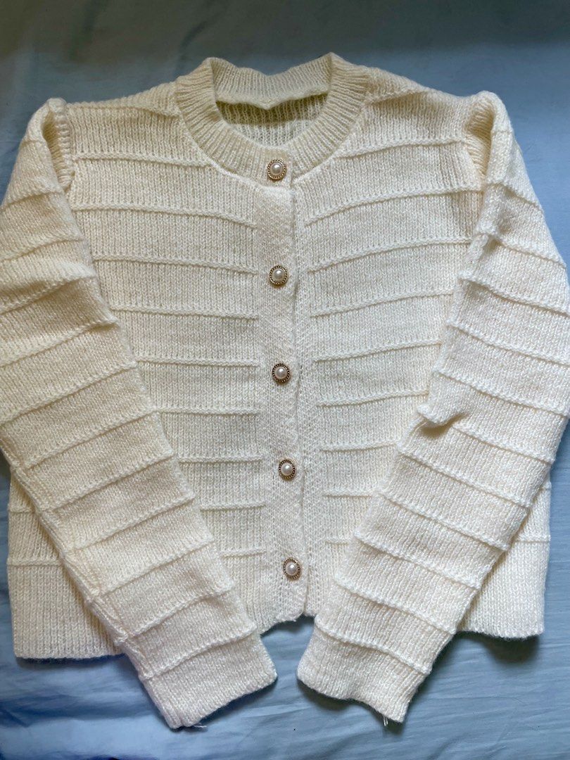 Cream Knitted Button-Up Cardigan (Category: Coats, Jackets and Outerwear) located in Cavite. Submitted by ynahmo (Listing ID 1460971015, Image 2). Description: - Cream knitted cardigan - Textured horizontal stripe pattern - Round neckline - Pearl button closure down the front - Cozy and chic design - Ideal for layering.