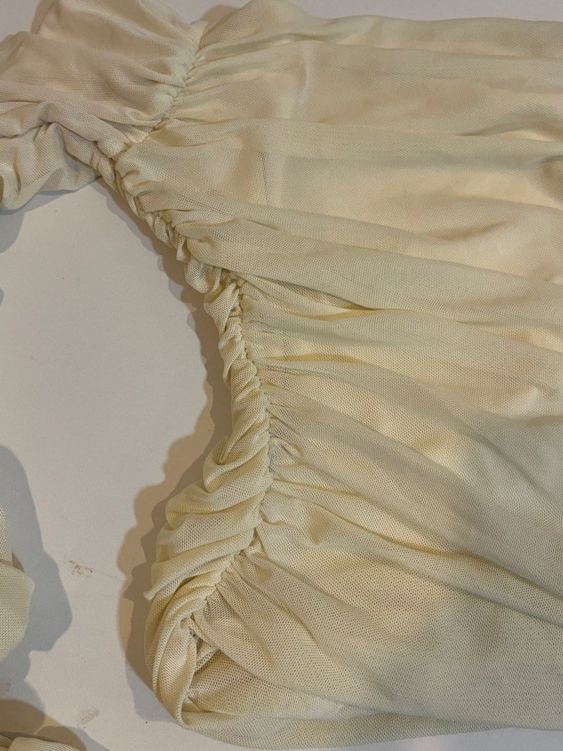 Cream Ruched Mesh Long Sleeve Top (Category: Longsleeves) located in Manila. Submitted by xoshushi.dcltr (Listing ID 1460974351, Image 3). Description: - Cream mesh top - Ruched detailing all over - Long sleeves with flared cuffs - Off-the-shoulder style - Very sheer material - Ideal for layering or a night out.