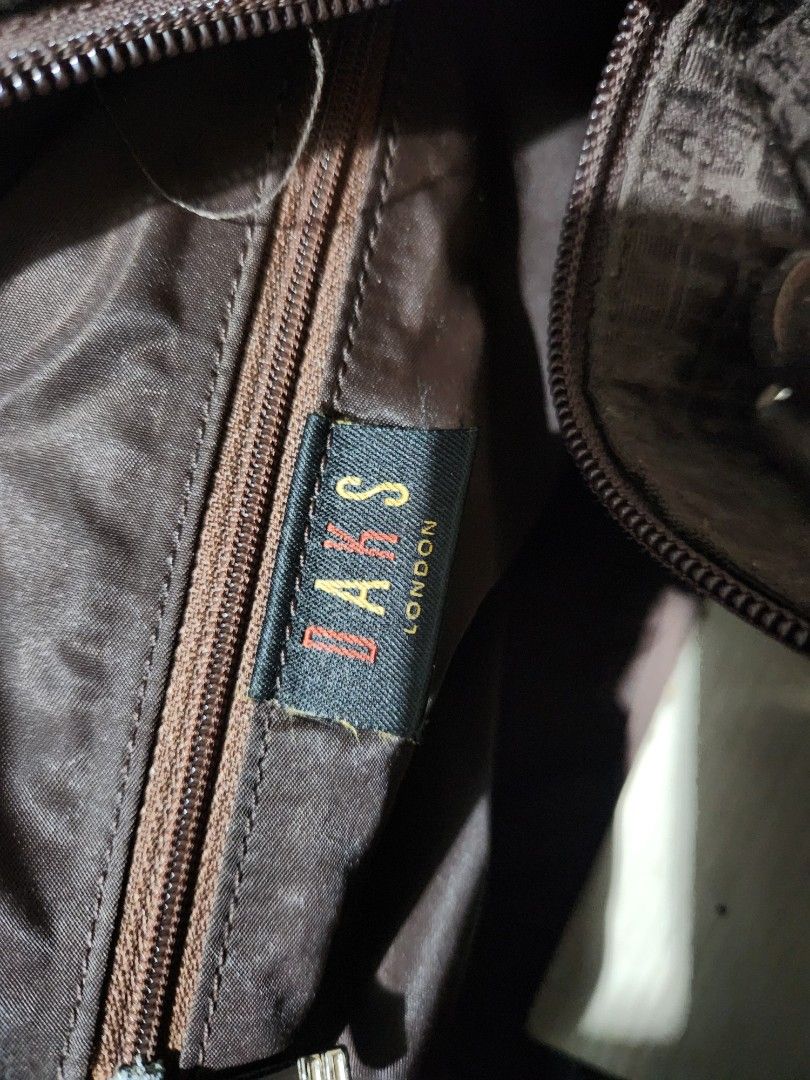 Daks London Brown Monogram Duffel Bag (Category: Luxury Bags & Wallets) located in Quezon City. Submitted by amber___18 (Listing ID 1461083739, Image 3). Description: - Authentic Brown Daks London duffel bag - Features iconic Daks monogram pattern all over - Genuine leather handles and trim for a premium feel - Secure zipper closure - Interior zippered pocket for essentials - Spacious enough for weekend trips or gym use 40 cm length 27 height 20 