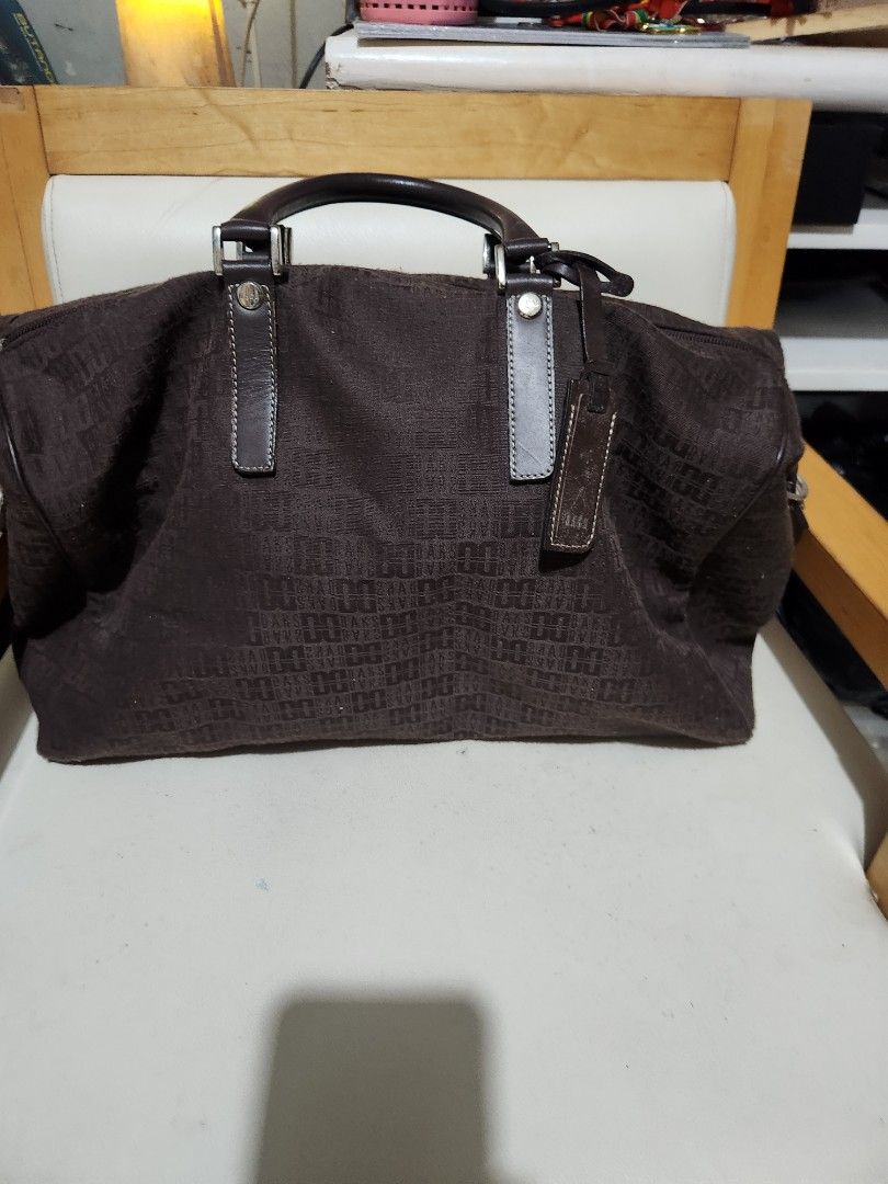 Daks London Brown Monogram Duffel Bag (Category: Luxury Bags & Wallets) located in Quezon City. Submitted by amber___18 (Listing ID 1461083739, Image 1). Description: - Authentic Brown Daks London duffel bag - Features iconic Daks monogram pattern all over - Genuine leather handles and trim for a premium feel - Secure zipper closure - Interior zippered pocket for essentials - Spacious enough for weekend trips or gym use 40 cm length 27 height 20 