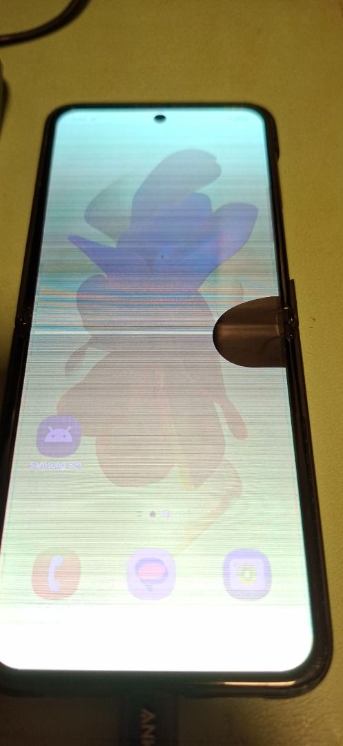 Defective Galaxy Z Flip4 (Category: Android Others) located in Quezon City. Submitted by kai-z_online (Listing ID 1393008535, Image 3). Description: Item is defective, find details below: 1. Screen has a green dot on upper portion of screen 2. Bottom half appears darker as seen on pics 2 and 3 3. Screen flickers when in use. 4. Black spot near the middle, right side of the screen. White line in middle screen. 5. Charger not included (USB C Charge