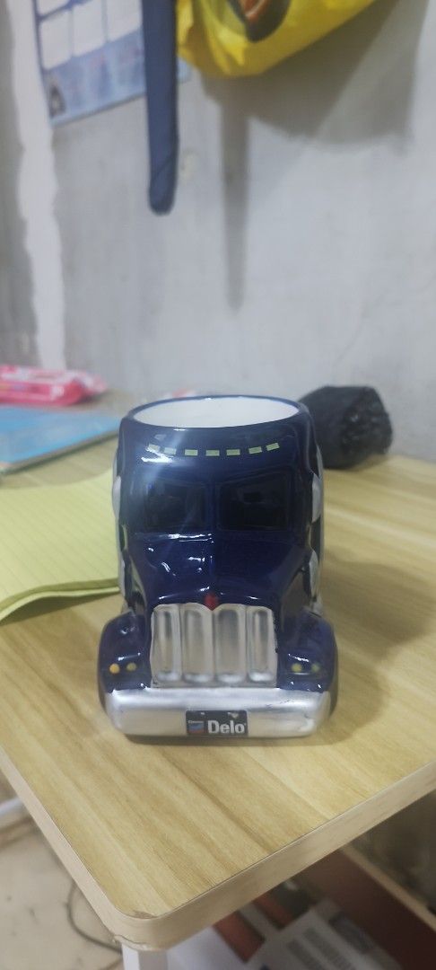 Delo Truck Ceramic Mug (Category: Coffee & Tea Tableware) located in Manila. Submitted by silverwhale_cafa21 (Listing ID 1461038309, Image 1). Description: - Unique mug shaped like a Delo truck - Dark blue color with silver accents - Features a convenient side handle - Ideal for enjoying coffee or tea - A must-have for truck enthusiasts and collectors.