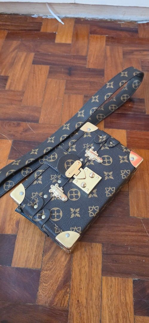 Designer Inspired Trunk Handbag with Strap (Category: Luxury Bags & Wallets) located in Caloocan City. Submitted by echoes_of_nnah (Listing ID 1461010889, Image 1). Description: - Cute mini trunk style handbag - Classic monogram print - Detachable strap included - Elegant gold hardware details - Ideal for evening events or as a statement piece Jimin purchase.