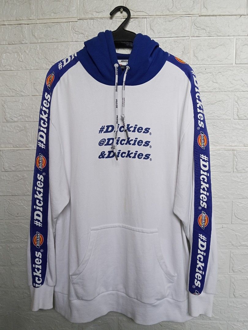 Dickies White Blue Graphic Hoodie (Category: Hoodies) located in Apalit. Submitted by grandocean.69bd38 (Listing ID 1461029544, Image 1). Description: - Dickies Hoodie - Color: White with Blue Accents - Size: Large (L) - Features Dickies logo and social media handles on the front - Dickies logo tape detail down the sleeves - Blue hood with adjustable drawstrings Size: Large on tag Dimes: 23 x 30 Verygood Condition Mine: 750.