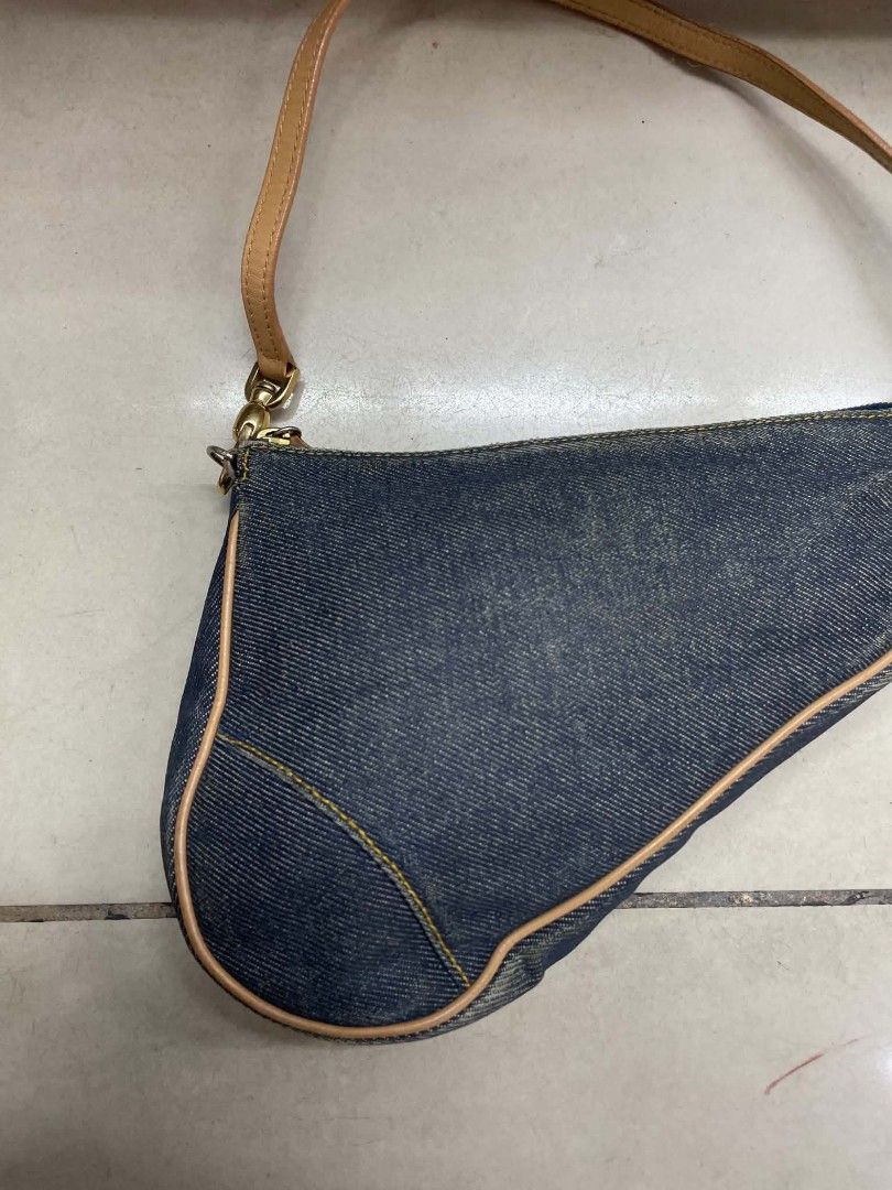 Dior Denim Saddle Bag (Category: Luxury Bags & Wallets) located in Cainta. Submitted by mariss.luxx (Listing ID 1461047797, Image 3). Description: - Classic Dior saddle bag - Dark wash denim material - Tan leather trim and strap - Gold hardware details - Zipper closure - Small size, perfect for essentials - A timeless addition to any collection.