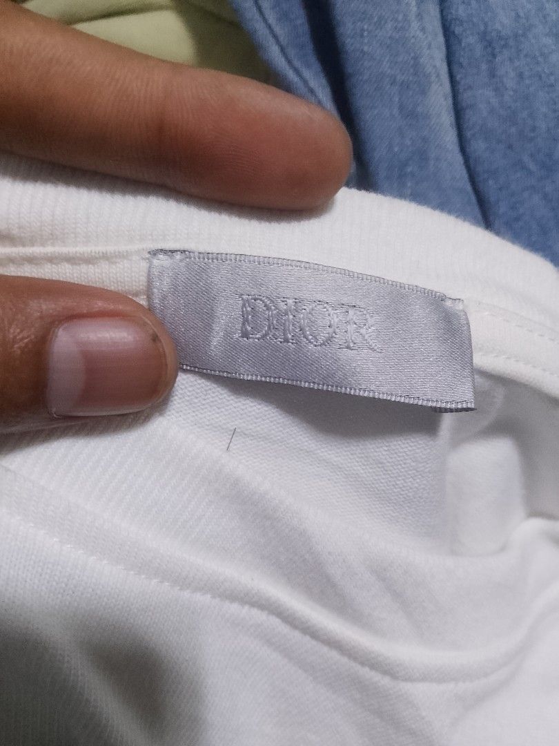 Dior White T-Shirt CD Logo (Category: Shirts) located in Quezon City. Submitted by theoneshop1 (Listing ID 1460953723, Image 3). Description: - Authentic White Dior T-Shirt - Size: XS - Features iconic CD logo on the front - Unique large circular graphic on the back - Material: 100% Cotton - Made in Italy.