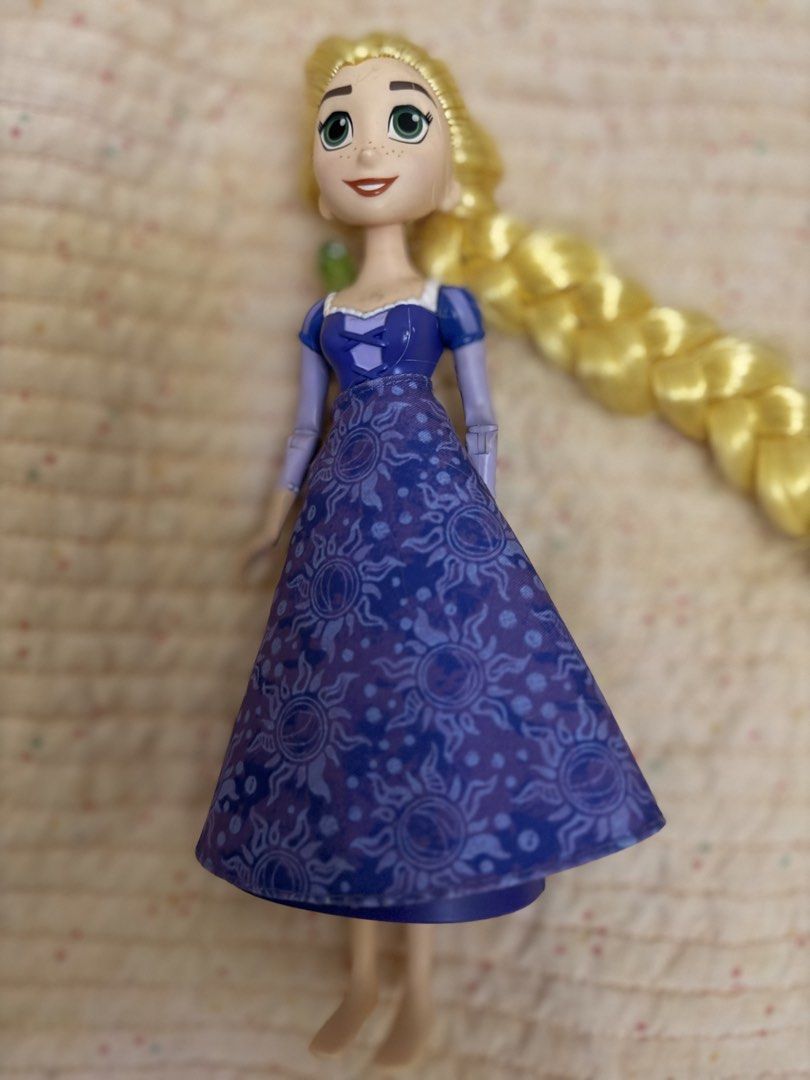 Disney Rapunzel Doll with Pascal new displayed only (Category: Kids Toys) located in Talisay. Submitted by secondsbyvan (Listing ID 1461004116, Image 2). Description: - Disney's Rapunzel doll from Tangled - Features her signature long blonde braid - Includes her friend Pascal perched on her shoulder - Wears her iconic purple dress with sun patterns - Ready for imaginative play and new adventures.