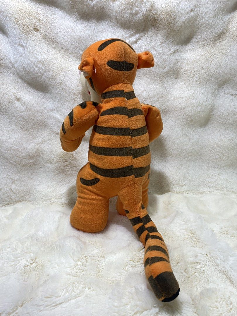 Disney Tigger Plush Toy (Category: Plushies & Soft Toys) located in Kalibo. Submitted by ollie_stuffshop (Listing ID 1460951173, Image 2). Description: 33cm x 17.5cm Before you send your inquiries: ❗️Last Price is already posted ❗️Manage your expectations, WYSIWYG ❗️May need washing ❗️Dropoff is every Wednesday & Sunday - Classic Tigger plush toy - Features iconic orange and black stripes - Stands upright on its own - Ideal for any Winnie the Poo