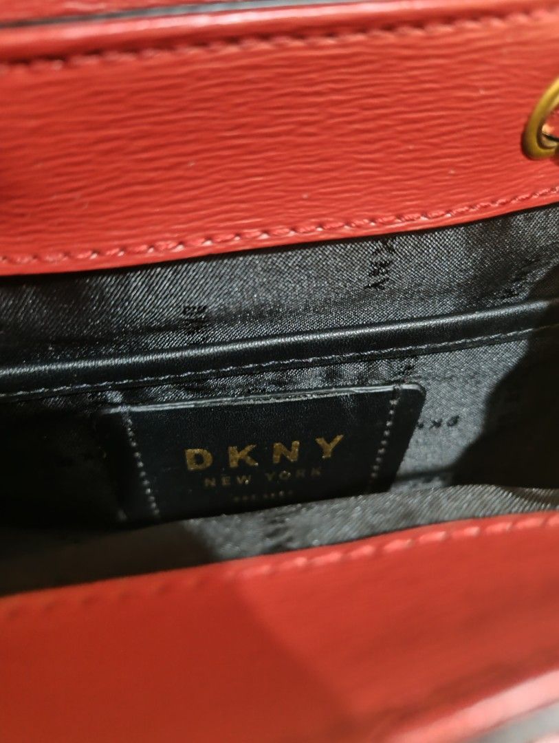 DKNY Red Leather Mini Backpack with Gold Chain (Category: Backpacks) located in Manila. Submitted by Marycali8I16 (Listing ID 1461106516, Image 3). Description: - Cute red DKNY mini backpack - Genuine leather material - Gold hardware accents - Top handle and adjustable straps for versatile carrying - Stylish chain detail on the back - Secure magnetic closure on the front flap - Branded interior lining - Ideal for everyday wear or evening outings.