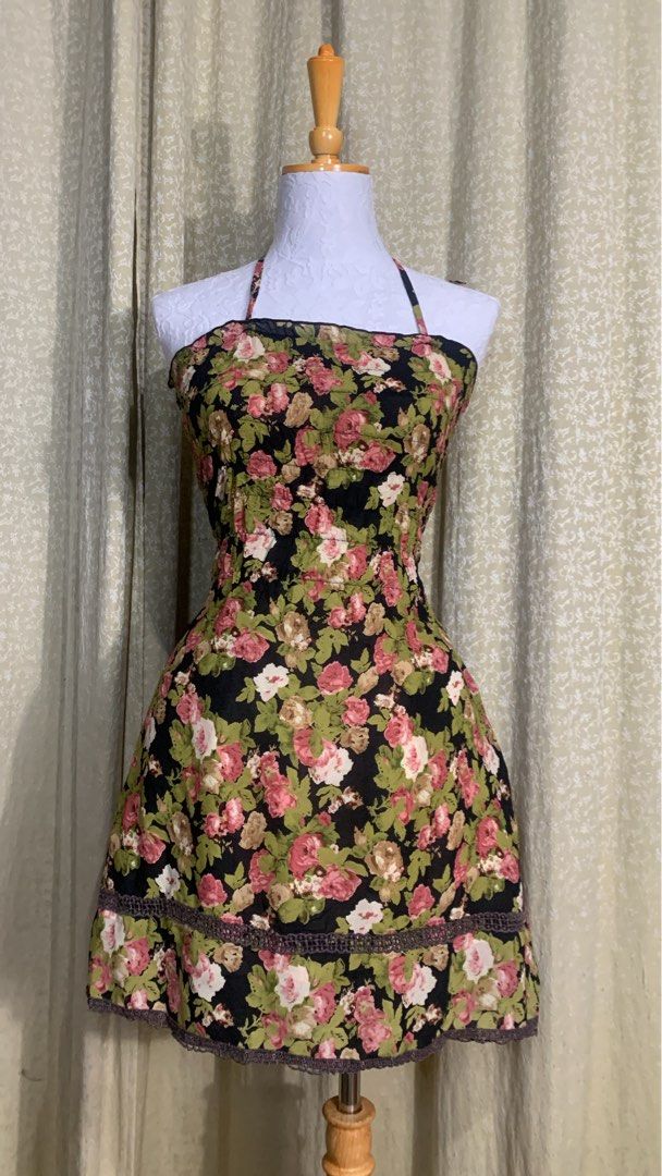 Dress cute (Category: Dresses) located in Dagupan City. Submitted by sj_styles0910. (Listing ID 1461101463, Image 1). Description: - Cute floral print dress - Size: XS (EU 34 / UK 6 / US 2) - Color: Black with pink, white, and green floral pattern - Design: Halter neck, smocked bodice for a flattering fit - Detail: Lace trim at the hem - Style: Feminine and sweet, perfect for casual wear.