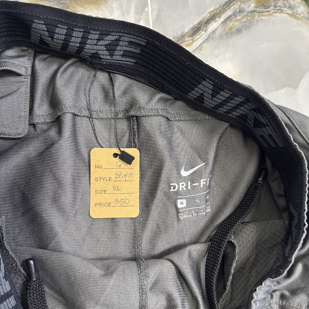 Dri-fit nike shortpants (Category: Shorts) located in Baguio. Submitted by kayeonlineshop (Listing ID 1461001410, Image 2). Description: dark gray athletic shorts featuring an elastic waistband and contrasting mesh hem panels. w31 L19 H23.