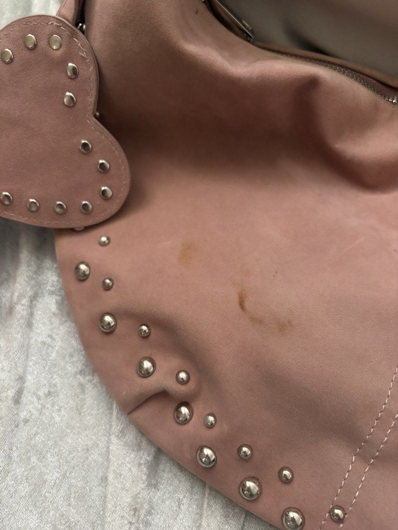Dusty Rose Suede Studded Shoulder Bag (Category: Shoulder Bags) located in Manila. Submitted by violoot (Listing ID 1460990211, Image 3). Description: Feminine and effortlessly chic, featuring a soft dusty-rose tone, studded detailing, and a charming heart accent. - has stain marks check 4th pic for reference -from pull and bear.