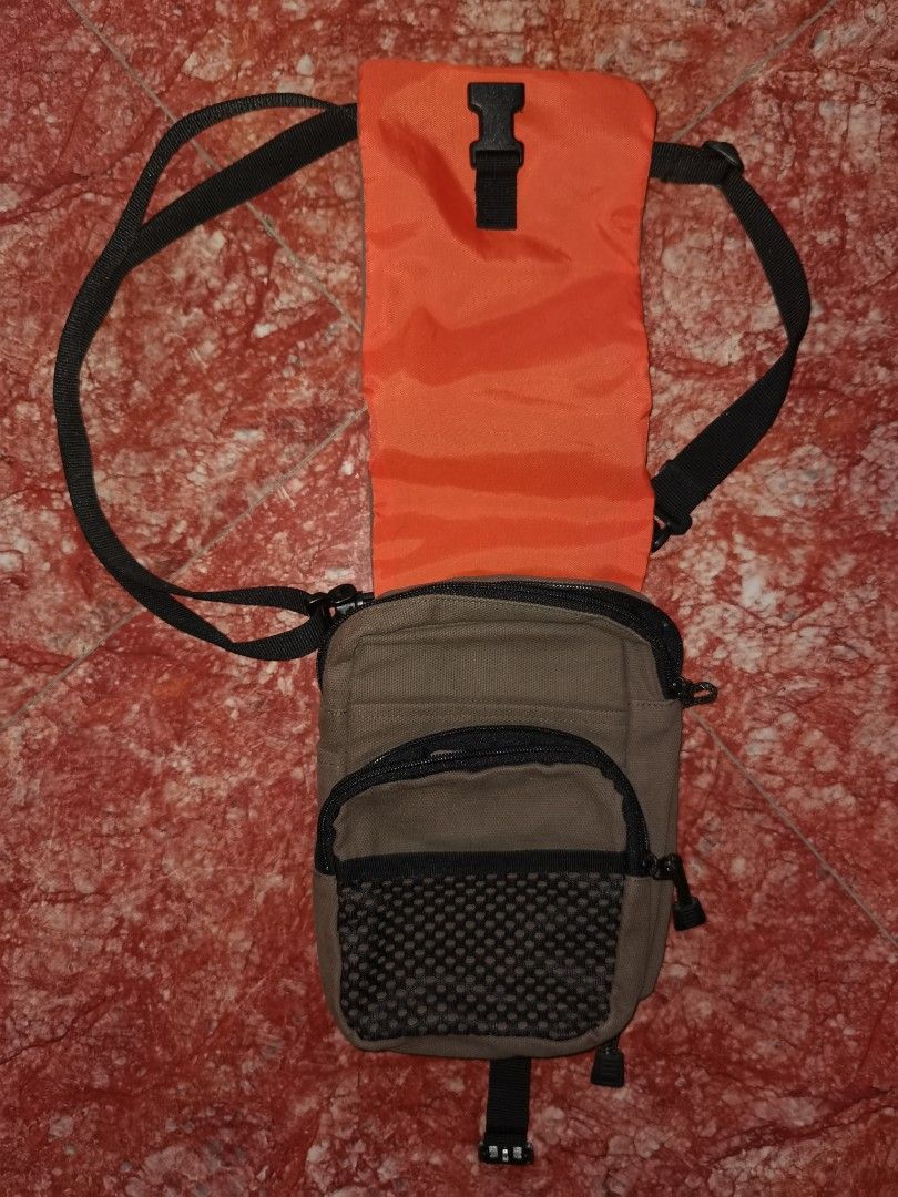 Ecko Unltd. Khaki Canvas Crossbody Bag (Category: Sling Bags) located in Caloocan City. Submitted by cooldudeszion (Listing ID 1460960972, Image 2). Description: - Brand: Ecko Unltd. - Color: Khaki - Style: Crossbody bag - Material: Canvas - Features: Multiple compartments and pockets for organization, adjustable strap, front flap with buckle closure, small zippered pocket on the front. - Condition: Shows some signs of wear but still functional. 