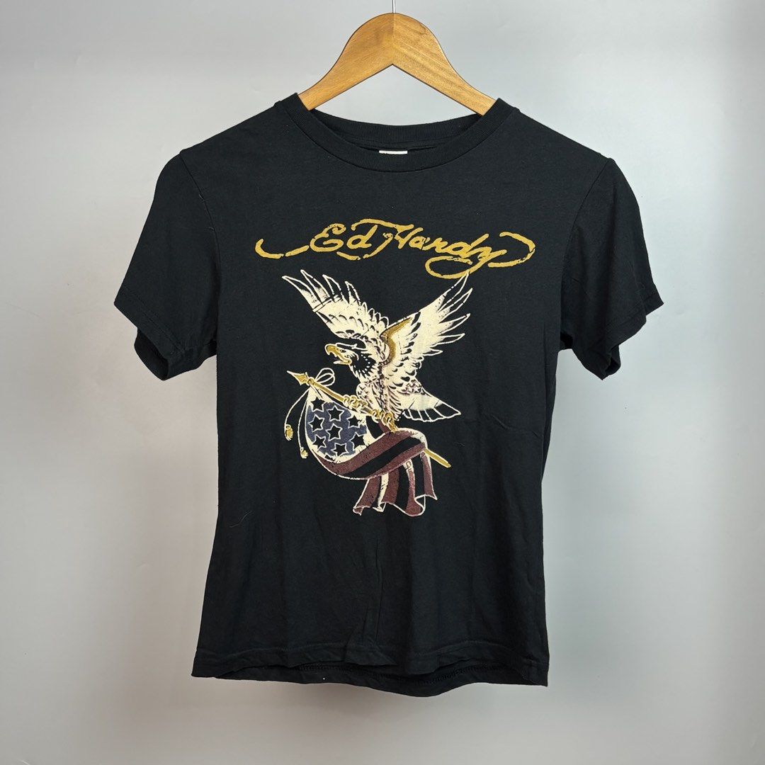 Ed Hardy Eagle & Flag Graphic T-Shirt Size M (Category: Shirts) located in Santa Maria. Submitted by dazzle_thrifts (Listing ID 1461015981, Image 1). Description: Excellent condition Flaws: none Size: S-M Width: 16 Length: 20 .