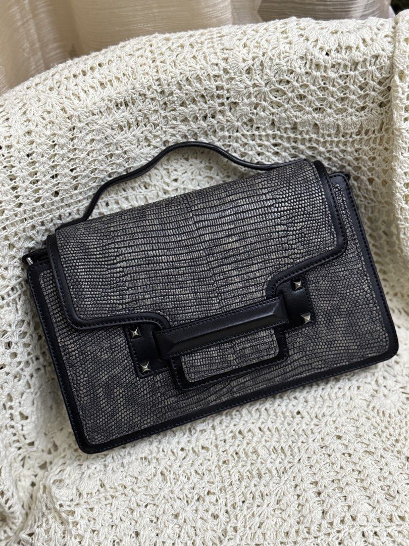 elegant Decke structured top-handle handbag (Category: Shoulder Bags) located in Bacolod City. Submitted by vintage_vogue6100 (Listing ID 1461001471, Image 1). Description: - Cool textured shoulder bag - Black with a reptile-like pattern - Top handle and flap closure - Stud details on the front - Interior zip closure - Ideal for going out.