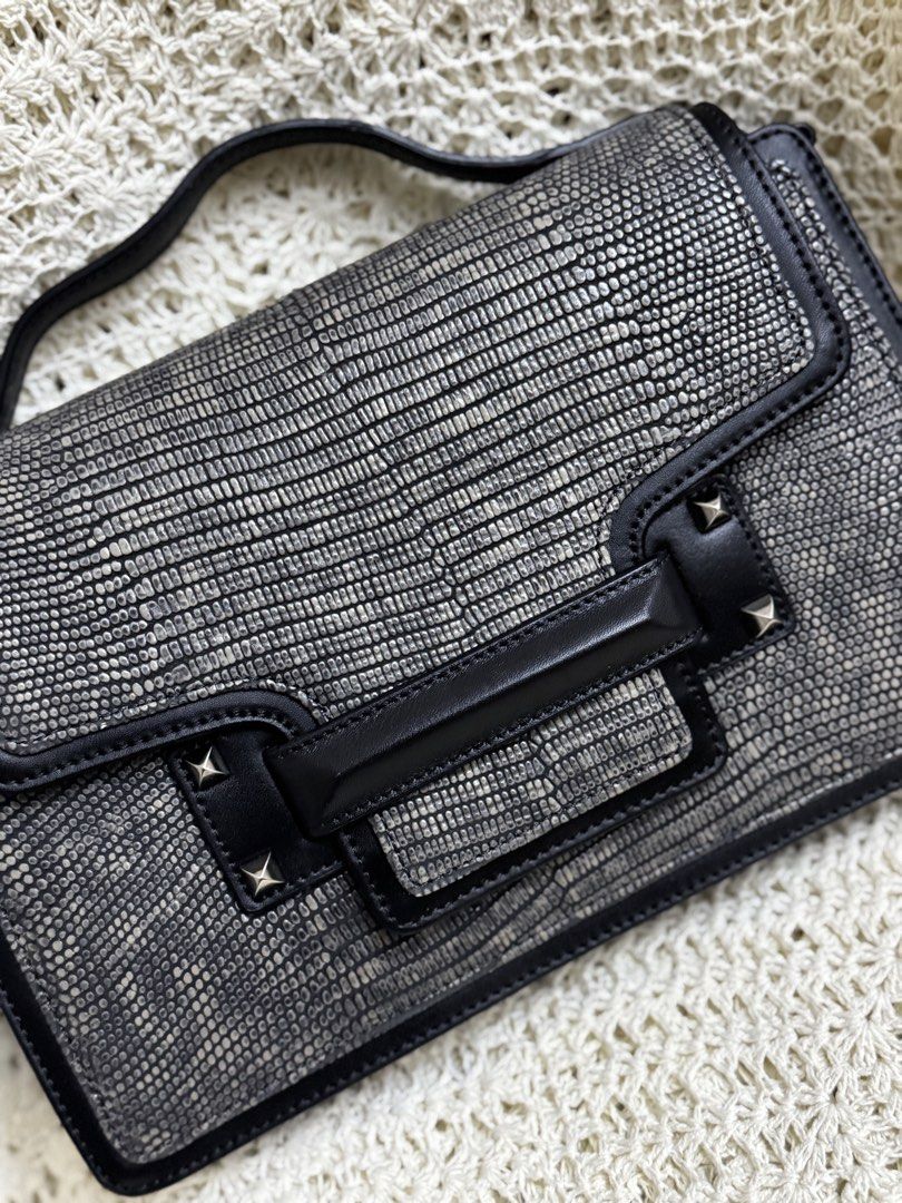 elegant Decke structured top-handle handbag (Category: Shoulder Bags) located in Bacolod City. Submitted by vintage_vogue6100 (Listing ID 1461001471, Image 2). Description: - Cool textured shoulder bag - Black with a reptile-like pattern - Top handle and flap closure - Stud details on the front - Interior zip closure - Ideal for going out.