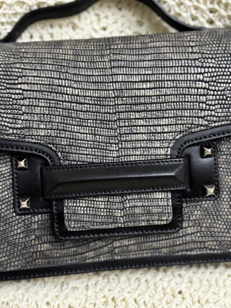 elegant Decke structured top-handle handbag (Category: Shoulder Bags) located in Bacolod City. Submitted by vintage_vogue6100 (Listing ID 1461001471, Image 3). Description: - Cool textured shoulder bag - Black with a reptile-like pattern - Top handle and flap closure - Stud details on the front - Interior zip closure - Ideal for going out.