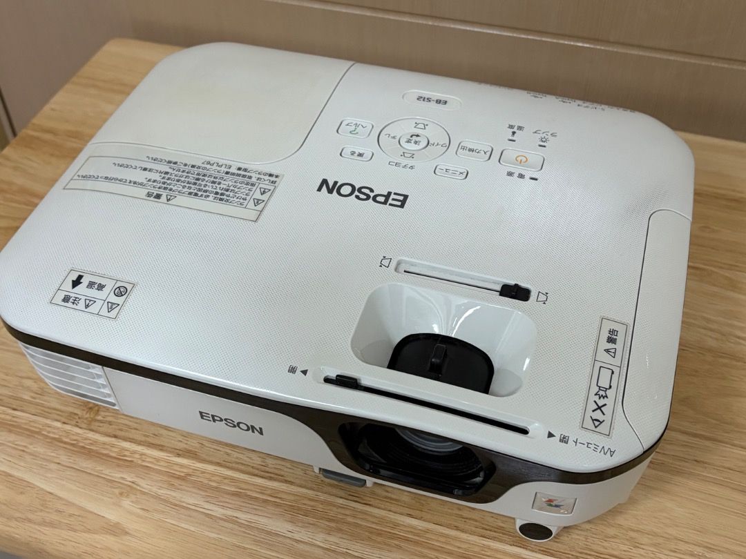 EPSON EB-S12 H430D Projector (USED) (Category: Projectors) located in Caloocan City. Submitted by paulmarting (Listing ID 1461027017, Image 3). Description: Epson EB-S12 H430D Projector Pre-owned and in working condition. Lamp Hours: • Normal Mode: 1,215 H • ECO Mode: 189 H Condition / Remarks: • Cosmetic scratches • Sticker residue/stains • Dirt and signs of use • Please see photos for the actual condition Included: Power cord VGA cable Carrying