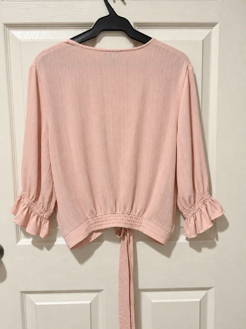 Express - Pink Tie-Front Blouse with Ruffle Sleeves (Category: Blouses) located in Cebu City. Submitted by classy82 (Listing ID 1461080878, Image 3). Description: - Cute pink tie-front blouse - Long sleeves with ruffle cuffs - Textured fabric - Versatile: pairs well with high-waisted pants or skirts - Ideal for casual outings or brunch dates - Easy to style and comfortable.