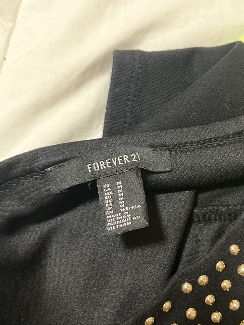 F21 Black Studded Crop Top with Spaghetti Straps (Category: Sleeveless) located in Quezon City. Submitted by prelovedbyhmsd (Listing ID 1461070422, Image 2). Description: - Black crop top - All-over gold stud detailing - Thin spaghetti straps - Stretchy material for a comfortable fit - Versatile for nights out or dressing up outfits - Pairs well with high-waisted jeans or skirts.