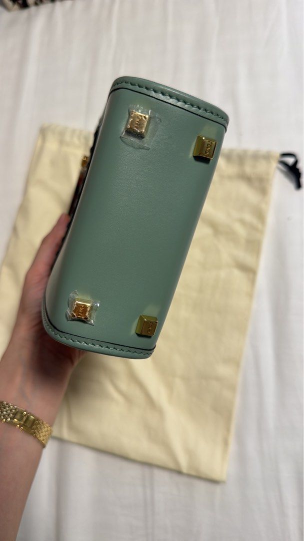 Fendi Roma Mini Bag (Category: Luxury Bags & Wallets) located in Pasig City. Submitted by regden (Listing ID 1460962976, Image 3). Description: - Authentic Fendi mini bag - Chic light green color - Unique tortoise shell handle - Comes with dust bag and authenticity card - Elegant gold hardware details - Perfect for carrying your essentials.