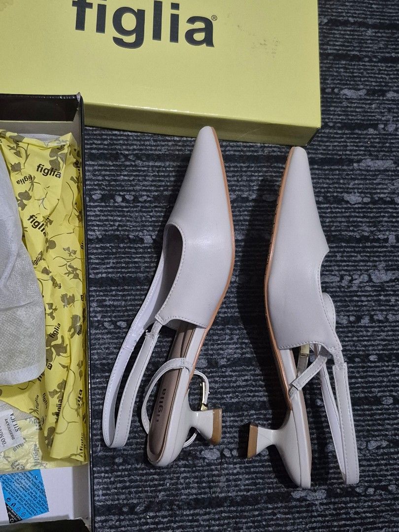 Figlia White Slingback Pointed Toe Heels Size 38 (Category: Heels) located in Antipolo. Submitted by pureeagle_4ba478 (Listing ID 1460987688, Image 3). Description: - Brand: Figlia - Type: Slingback Heels - Color: White - Size: 38 - Features: Pointed toe, delicate ankle strap with buckle closure, unique sculpted heel shape - Condition: Comes with original box and packaging - Versatility: Great for dressing up or down Used once for an event. .