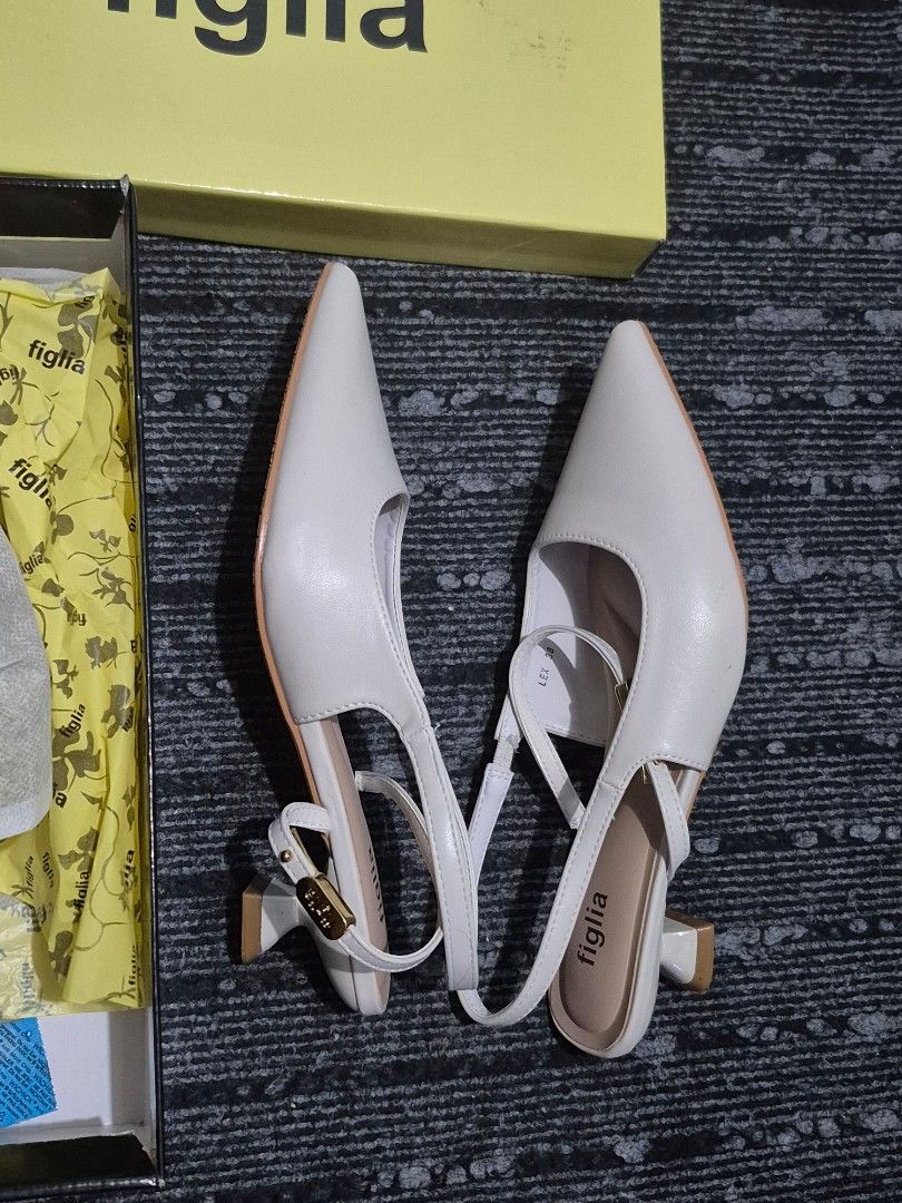 Figlia White Slingback Pointed Toe Heels Size 38 (Category: Heels) located in Antipolo. Submitted by pureeagle_4ba478 (Listing ID 1460987688, Image 2). Description: - Brand: Figlia - Type: Slingback Heels - Color: White - Size: 38 - Features: Pointed toe, delicate ankle strap with buckle closure, unique sculpted heel shape - Condition: Comes with original box and packaging - Versatility: Great for dressing up or down Used once for an event. .