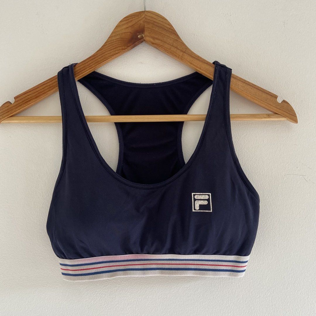 Fila Sports Bra (Category: Activewear) located in Angeles City. Submitted by eriellynnthrifts (Listing ID 1460948279, Image 1). Description: This is a navy blue FILA sports bra featuring a colorful striped elastic underband..