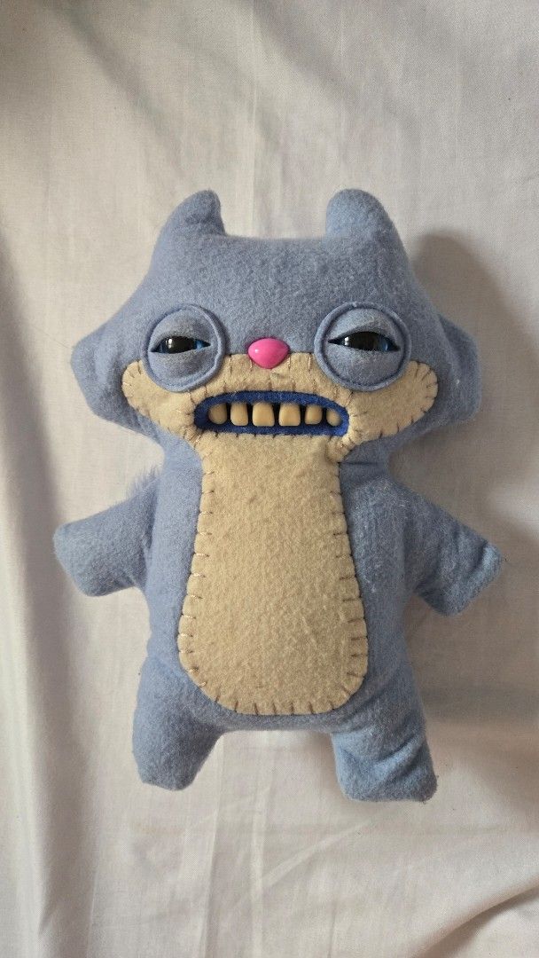 FUGGLER - Periwinkle Sketchy Squirrel (Category: Plushies & Soft Toys) located in Manila. Submitted by fierceriver.e57033 (Listing ID 1460953696, Image 1). Description: - No box, cut tag - Adorable handmade blue plush monster - Features big, expressive eyes and a wide mouth with visible teeth - Contrasting tan felt belly - Includes a fluffy blue tail - Soft, huggable, and perfect for collectors.