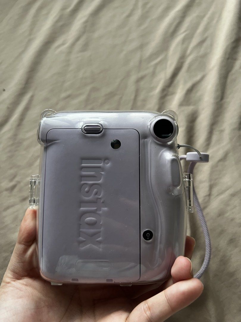 Fujifilm Instax Mini 11 Lavender Instant Camera (Category: Cameras) located in Valenzuela. Submitted by decluttering.manila (Listing ID 1461002943, Image 3). Description: - Lavender Fujifilm Instax Mini 11 camera - Comes with a clear protective case - Includes a wrist strap - 60mm lens with focus range from 0.3m to infinity - Ideal for capturing instant memories - Fully functional and works well.