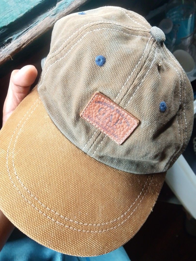 GAP American Traveler Cap (Category: Caps & Hats) located in Quezon City. Submitted by theoneshop1 (Listing ID 1460953423, Image 1). Description: - Classic GAP cap - Tan and brown colorway - Features a leather patch detail on the front - Made of 100% cotton - One size fits all - Ideal for everyday wear.