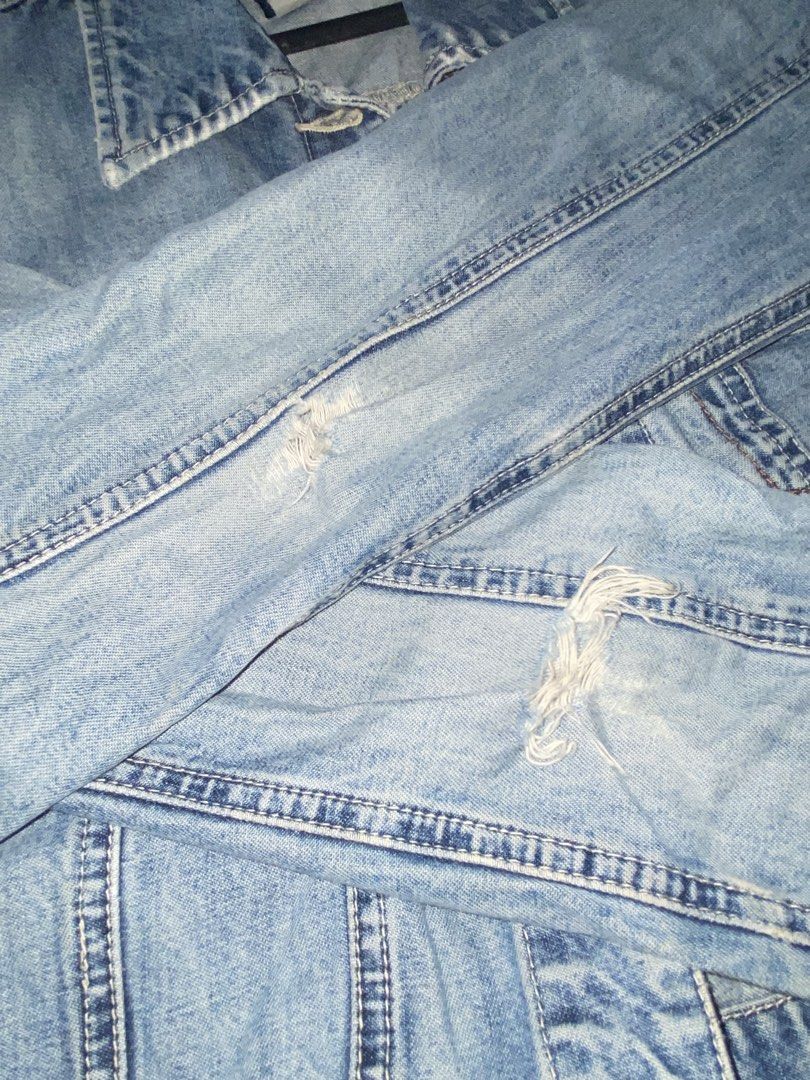GAP Denim Jacket Size S (Category: Coats, Jackets and Outerwear) located in Muntinlupa City. Submitted by oreonco (Listing ID 1461114906, Image 3). Description: - Classic blue denim jacket from GAP - 100% cotton - Button-up front - Two chest pockets - Distressed details on sleeves and front - Versatile staple piece for any wardrobe.