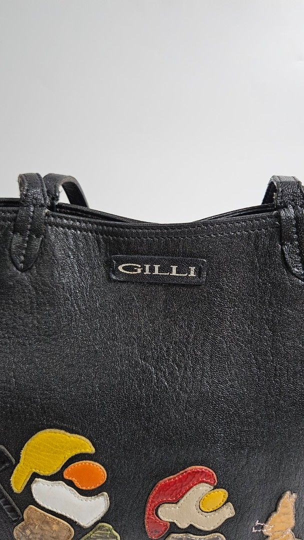 GILLI Black Leather Tote Bag (Category: Tote Bags) located in Alfonso. Submitted by jbcamet (Listing ID 1461033124, Image 2). Description: - GILLI black leather tote bag - Unique applique design on the front - Beige leather base - Interior zippered pocket - Brand tag inside - Black leather handles - Stylish and eye-catching design.