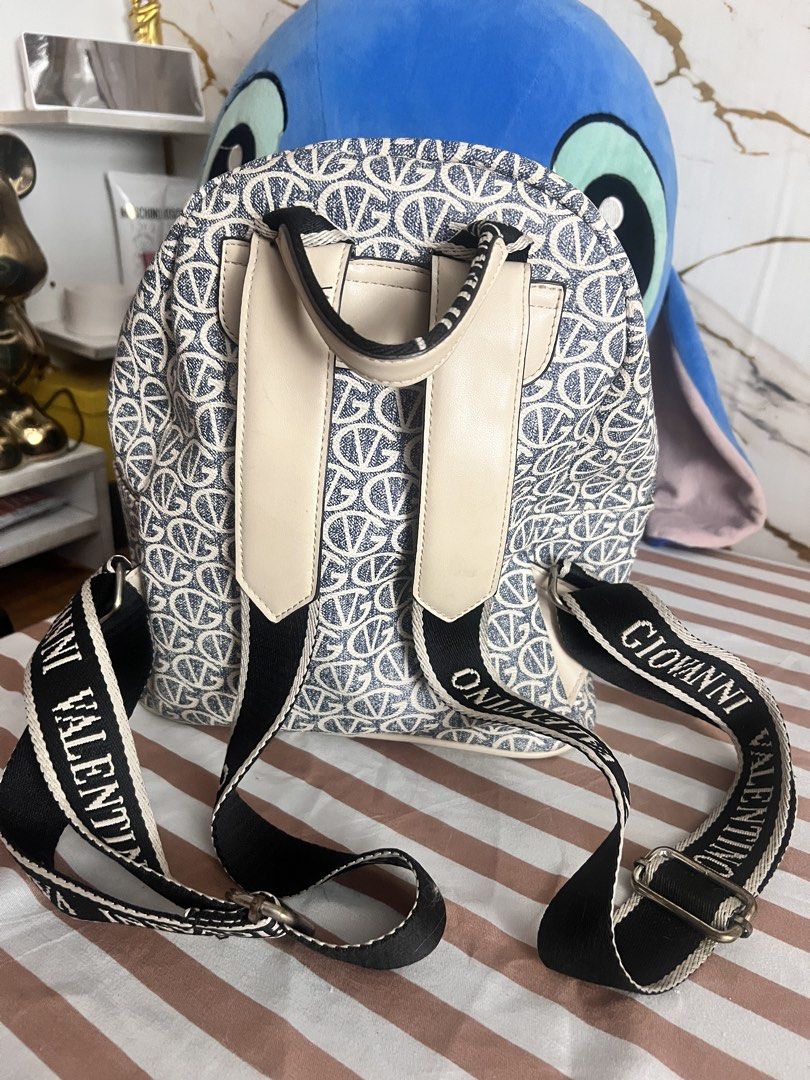 Giovanni Valentino Monogram Backpack (Category: Backpacks) located in Caloocan City. Submitted by queensproduct (Listing ID 1461064738, Image 2). Description: - Cute Giovanni Valentino backpack - All-over monogram print - Beige and navy blue colorway - Front zip pocket - Adjustable shoulder straps - Interior with striped lining and small zip pocket - Great for everyday use.
